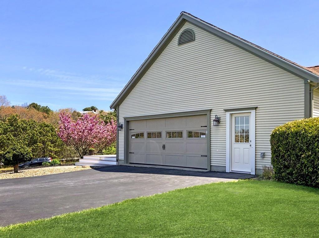 10 Weather Deck Road Bourne, MA 02532 - Photo 31 of 37 a front view of a house with a yard and garage