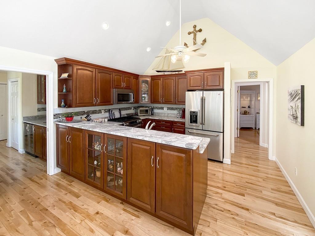 10 Weather Deck Road Bourne, MA 02532 - Photo 4 of 37 a kitchen with stainless steel appliances a refrigerator and a stove top oven