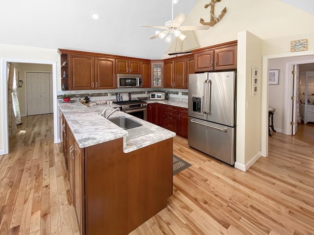 10 Weather Deck Road Bourne, MA 02532 - Photo 5 of 37 a kitchen with kitchen island a counter top space a refrigerator and a stove