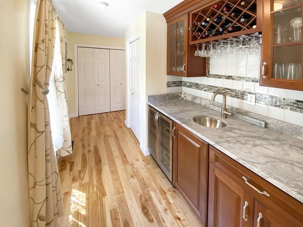 10 Weather Deck Road Bourne, MA 02532 - Photo 6 of 37 a kitchen with a sink stove and cabinets
