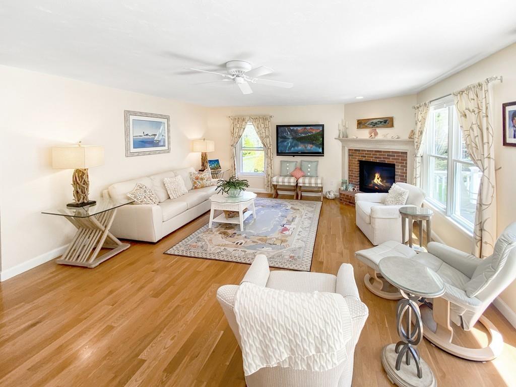 10 Weather Deck Road Bourne, MA 02532 - Photo 7 of 37 a living room with furniture a fireplace and a flat screen tv