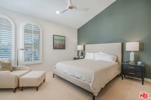a bedroom with bed and a couch