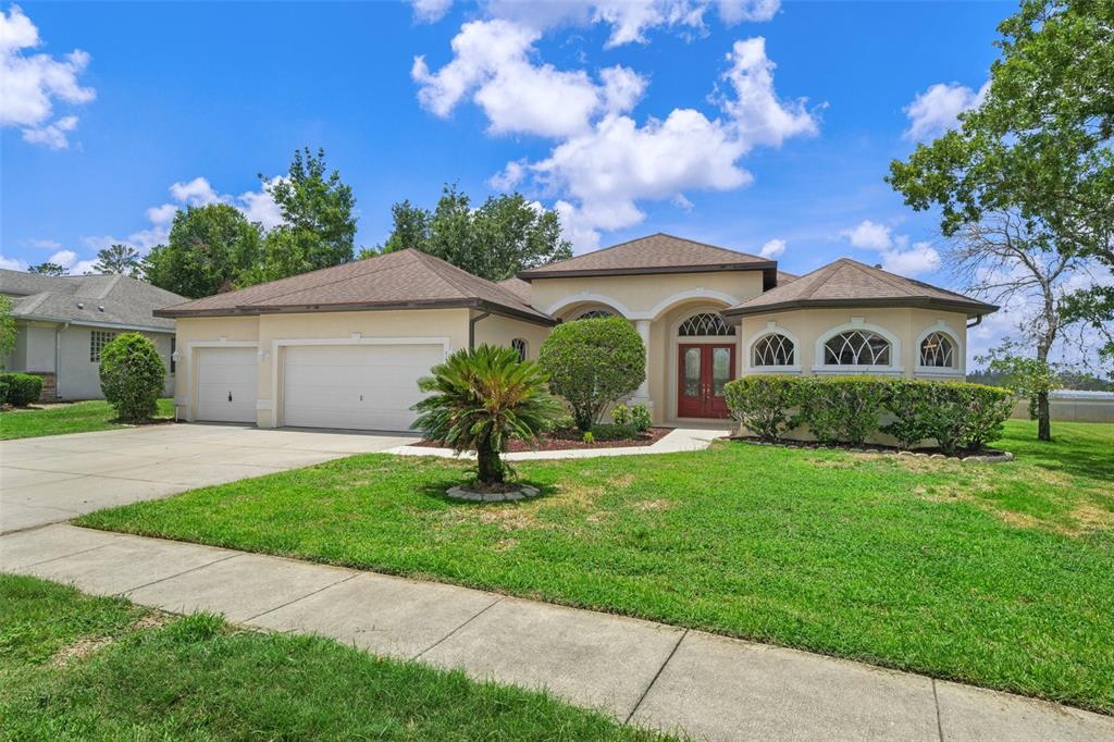 a front view of a house with a garden
