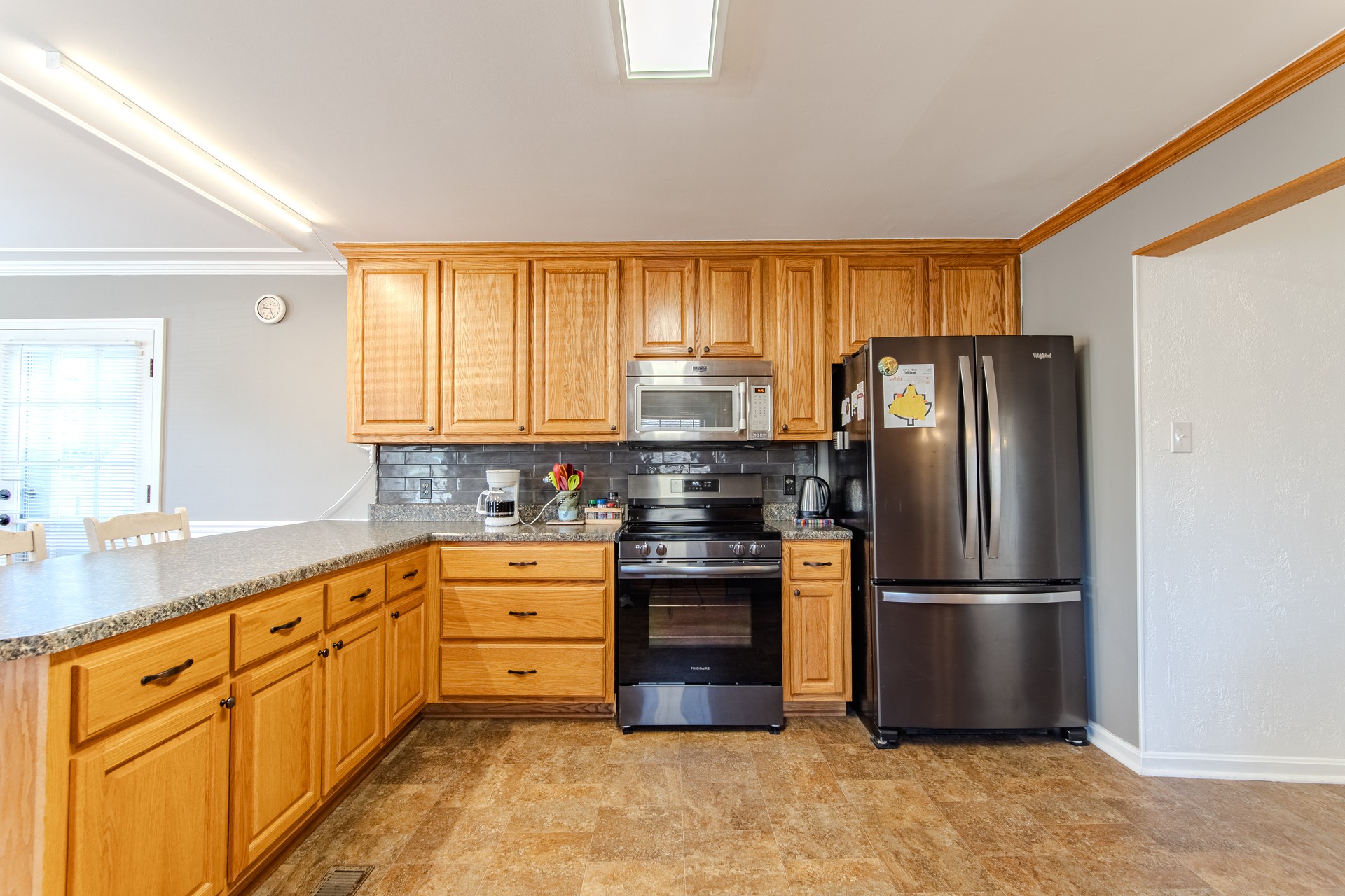 404 Highway 57 Ramer, TN 38367 - Photo 18 of 87 a kitchen with stainless steel appliances granite countertop a refrigerator a stove and a sink