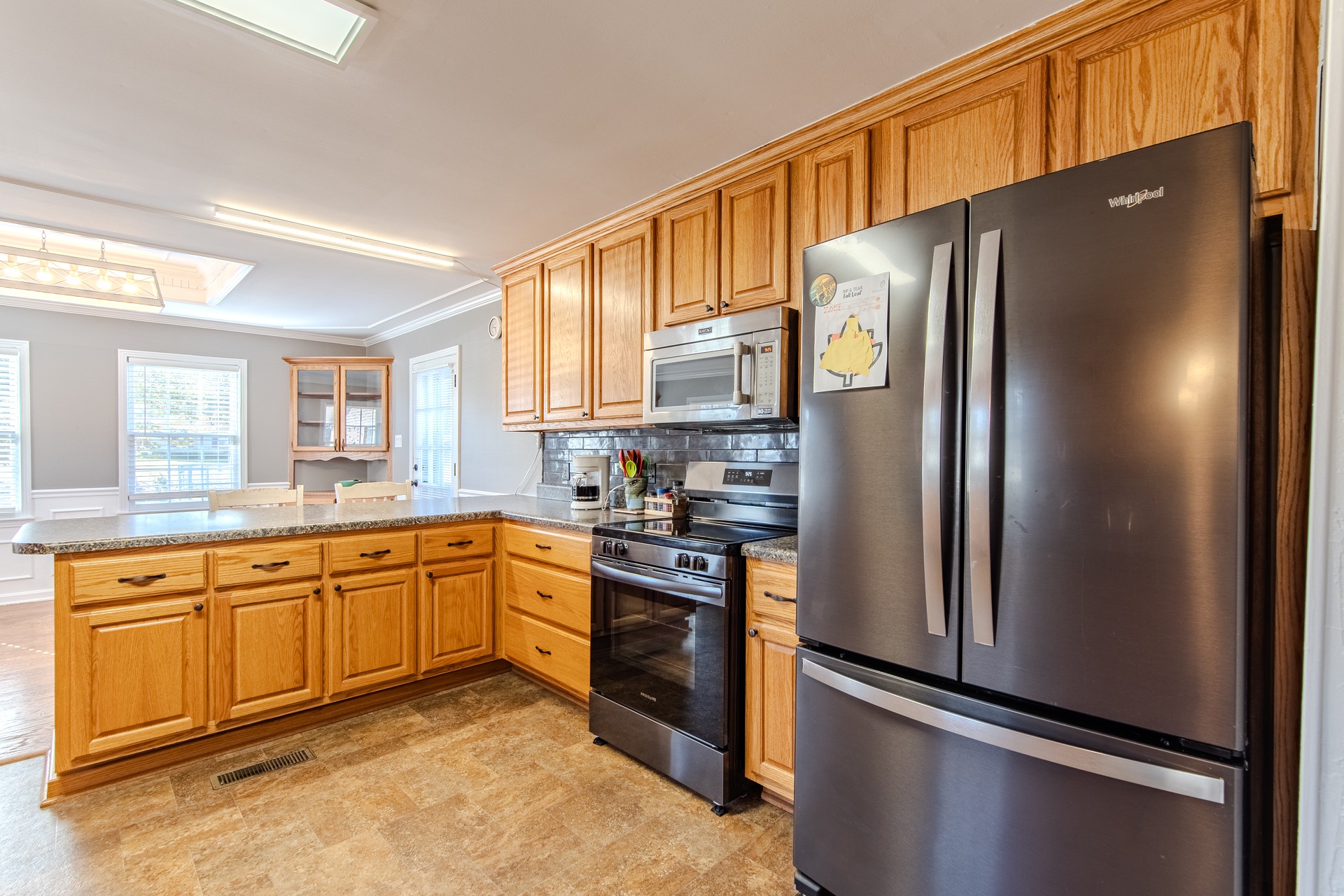 404 Highway 57 Ramer, TN 38367 - Photo 19 of 87 a kitchen with stainless steel appliances granite countertop a refrigerator a stove and a sink