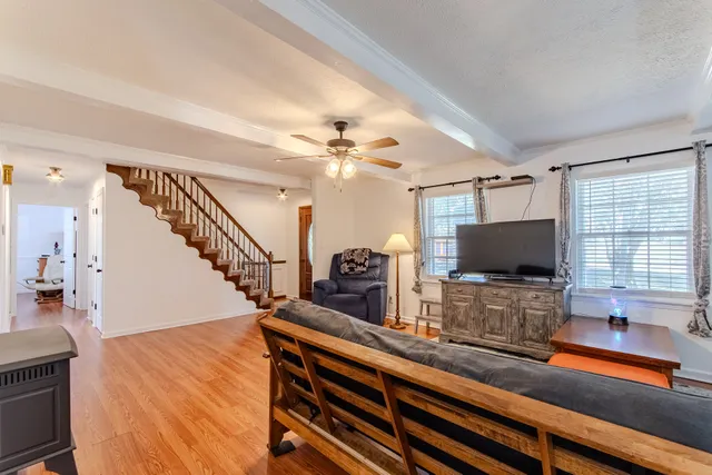 a spacious bathroom with a granite countertop sink a toilet a mirror and shower