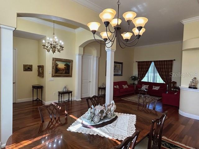 17127 Brown Road Odessa, FL 33556 - Photo 14 of 58 a dining room with wooden floor a chandelier a wooden table and chairs