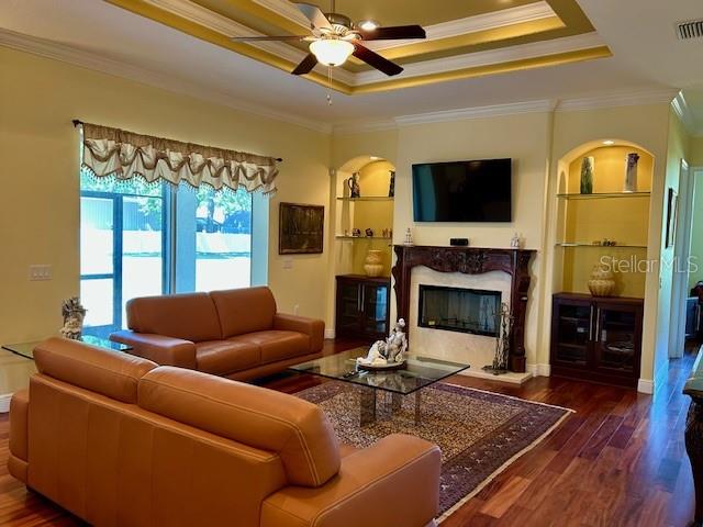 17127 Brown Road Odessa, FL 33556 - Photo 32 of 58 a living room with furniture a flat screen tv and a fireplace