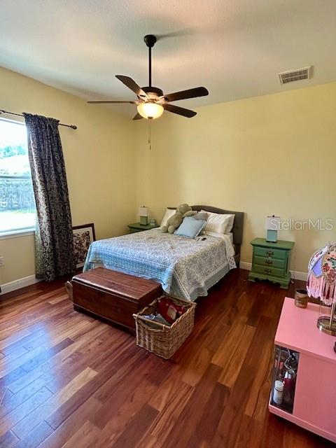 17127 Brown Road Odessa, FL 33556 - Photo 35 of 58 a bedroom with a bed window and wooden floor