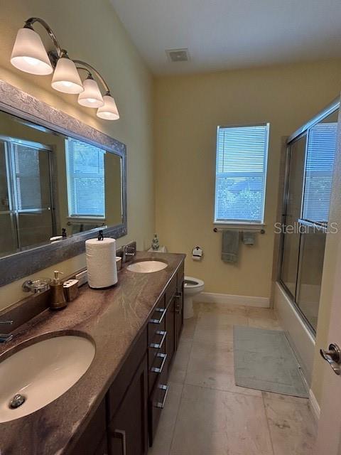 17127 Brown Road Odessa, FL 33556 - Photo 36 of 58 a bathroom with a granite countertop sink and a mirror