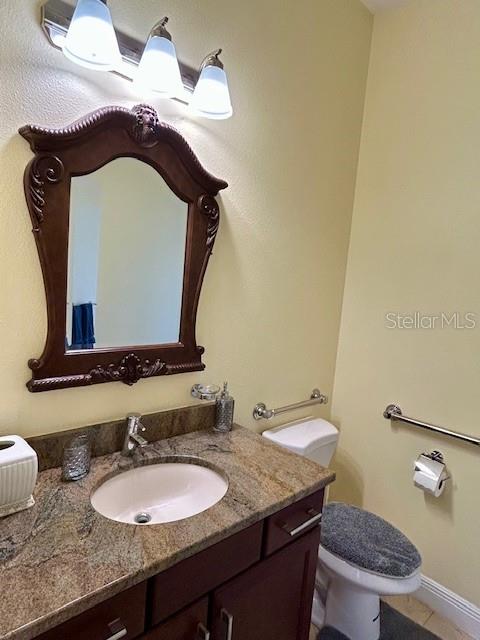 17127 Brown Road Odessa, FL 33556 - Photo 38 of 58 a bathroom with a granite countertop sink and a mirror
