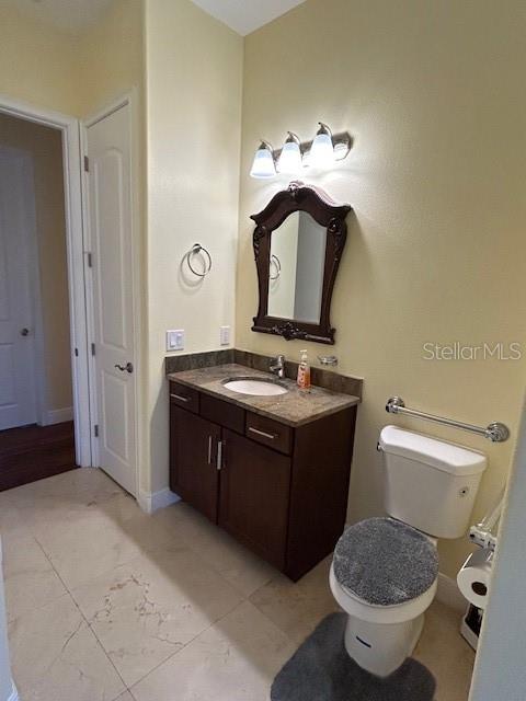 17127 Brown Road Odessa, FL 33556 - Photo 39 of 58 a bathroom with a toilet sink vanity and mirror