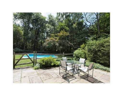 118 Pembroke Road Darien, CT 06820 - Photo 17 of 18 a view of a bench in a garden