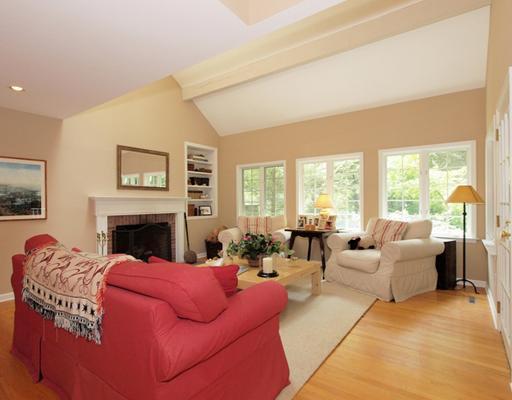 118 Pembroke Road Darien, CT 06820 - Photo 8 of 18 a living room with furniture large windows and a fireplace