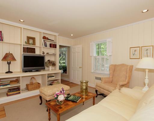 118 Pembroke Road Darien, CT 06820 - Photo 9 of 18 a living room with furniture flat screen tv and a fireplace