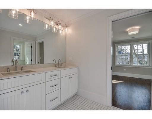 20 Mellon Road Wellesley, MA 02482 - Photo 19 of 25 a bathroom with a granite countertop sink a large mirror a vanity and a window