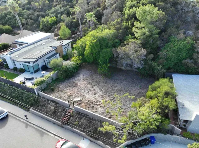 an aerial view of a house with a yard basket ball court and outdoor seating