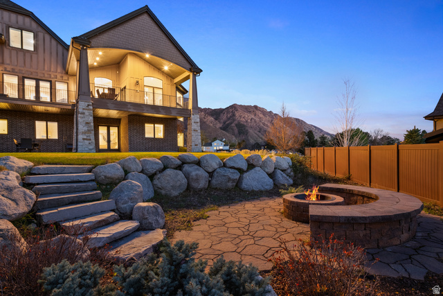 1205 North Elk Rdg Lane, Unit 202 Alpine, UT 84004 - Photo 85 of 88 Stone patio featuring a built-in fire pit with a curved seating wall