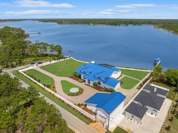an aerial view of a house with a ocean view