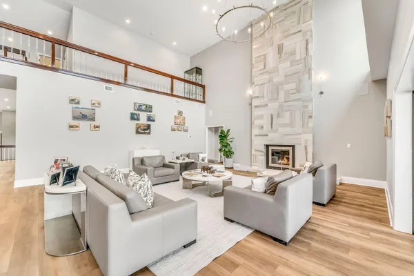 a kitchen with stainless steel appliances white cabinets and wooden floors