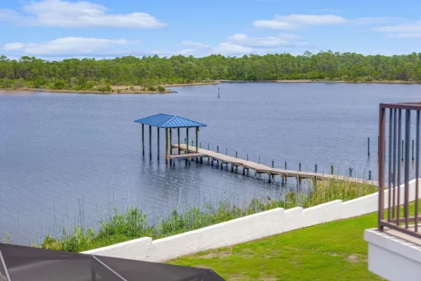 a bedroom with bed and wooden floor
