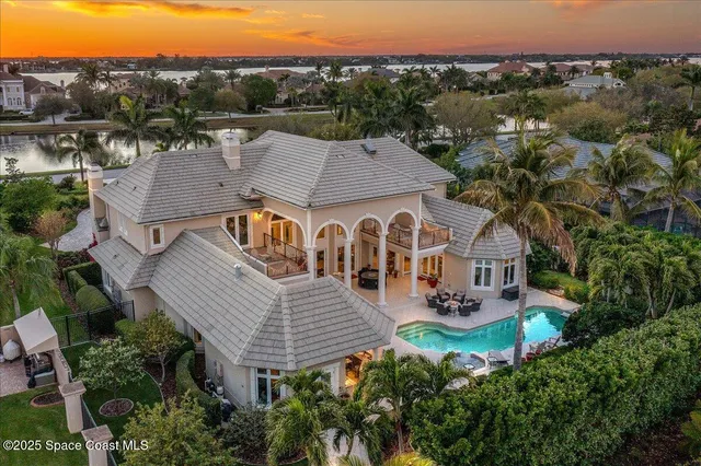 a view of a patio with couches and a table and chairs under an umbrella