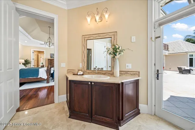 a view of a patio with a table and chairs and floor to ceiling window