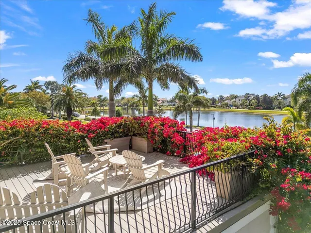 an aerial view of a house with a garden and lake view
