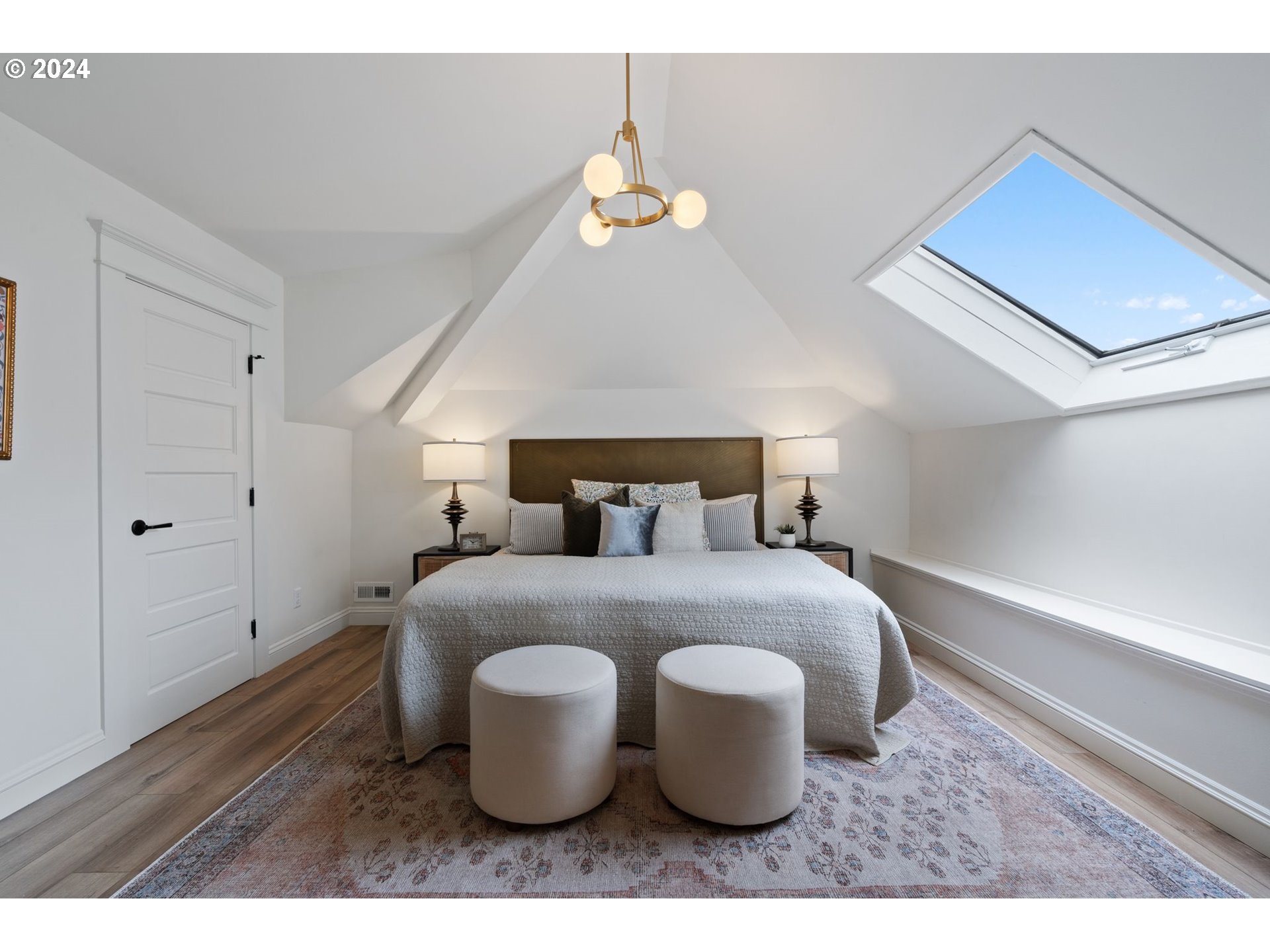 2548 Southwest St Helens Court Portland, OR 97201 - Photo 20 of 42 a large bed sitting in a room next to a chandelier