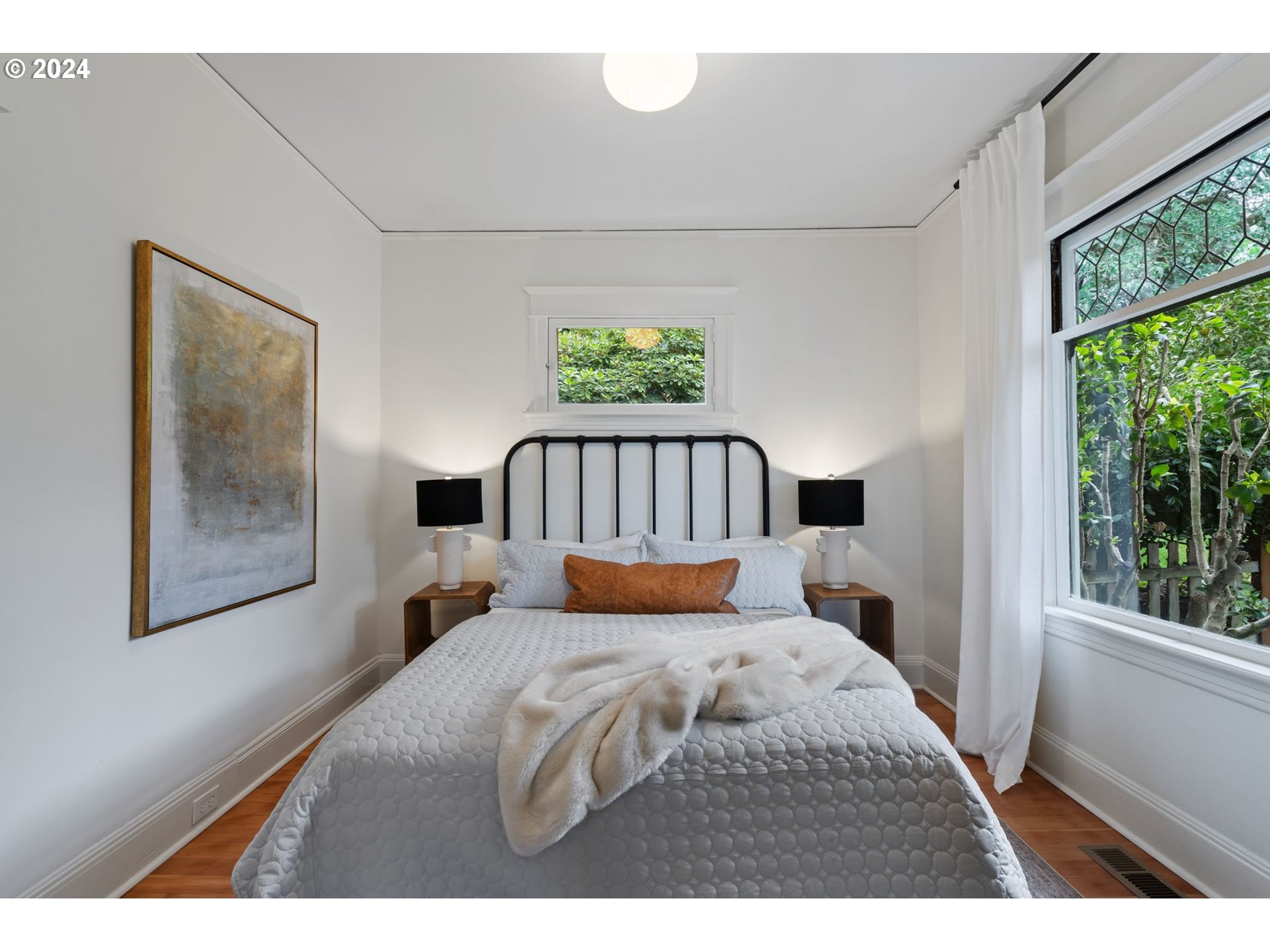 2548 Southwest St Helens Court Portland, OR 97201 - Photo 28 of 42 a bedroom with a bed and a painting on the wall