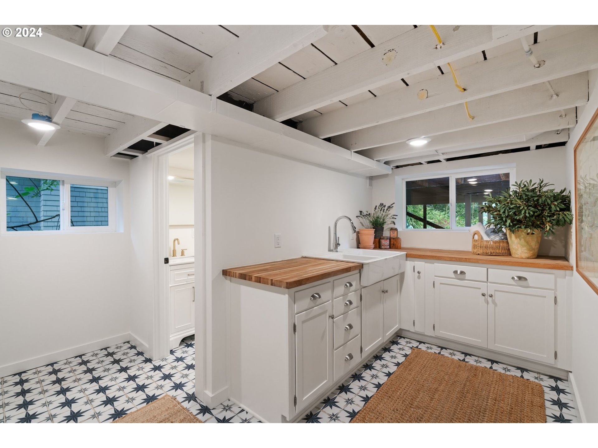 2548 Southwest St Helens Court Portland, OR 97201 - Photo 35 of 42 a kitchen with granite countertop a stove and white cabinets