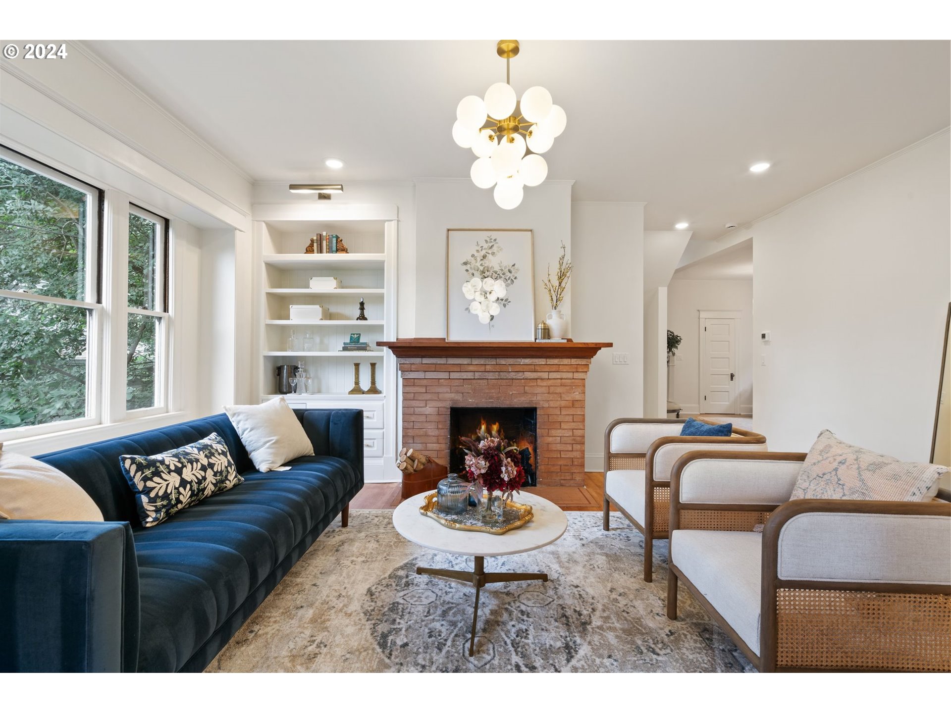2548 Southwest St Helens Court Portland, OR 97201 - Photo 5 of 42 a living room with furniture a chandelier and a fireplace