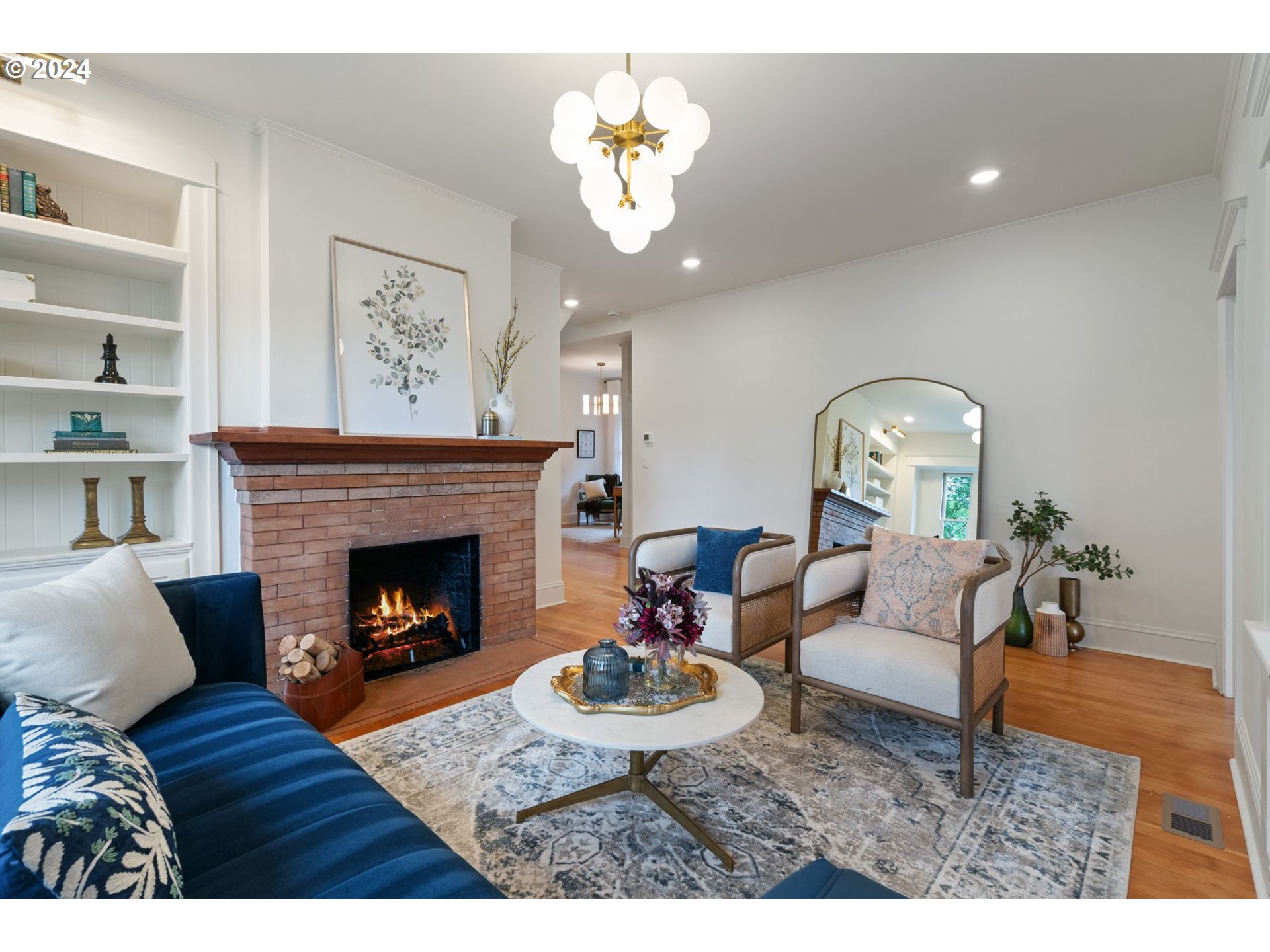 2548 Southwest St Helens Court Portland, OR 97201 - Photo 6 of 42 a living room with furniture a chandelier and a fireplace