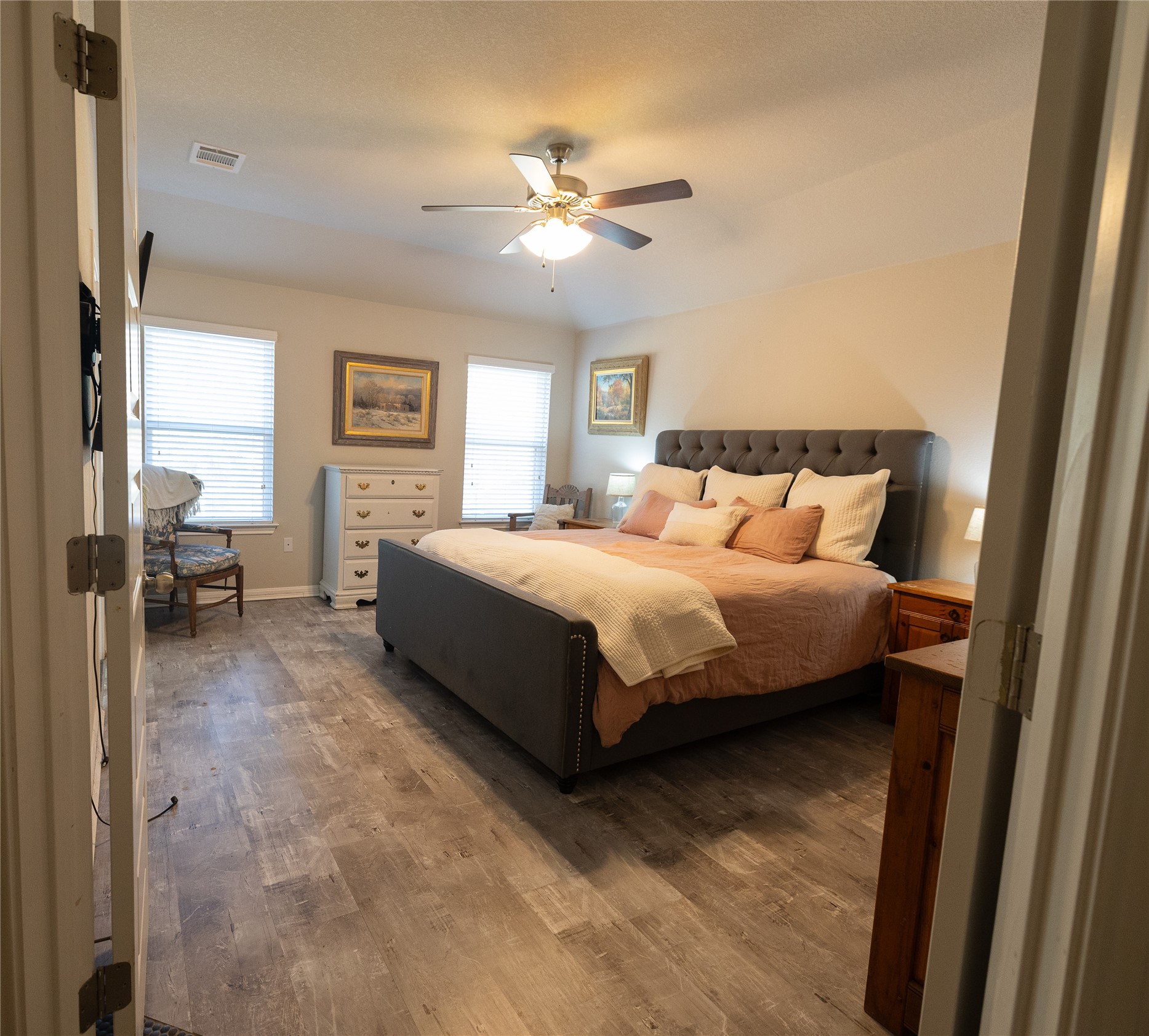 827 Savannah Cove Elgin, TX 78621 - Photo 11 of 31 Primary Bedroom with French door entrance and a ceiling fan
