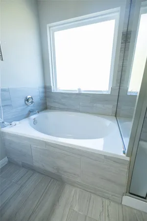 a white bath tub sitting next to a window