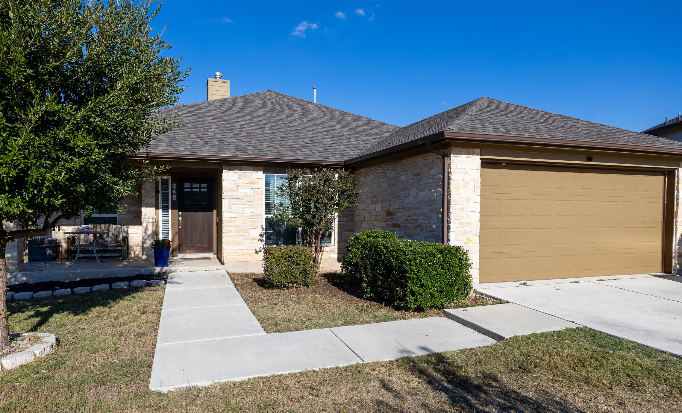 827 Savannah Cove Elgin, TX 78621 - Photo 5 of 31 View of front of property featuring a shingled roof, stone siding, and attached garage