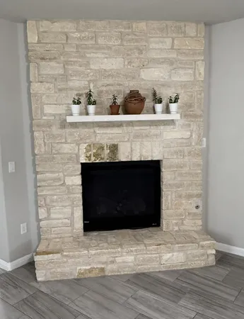 a room with a fireplace and a wooden floor