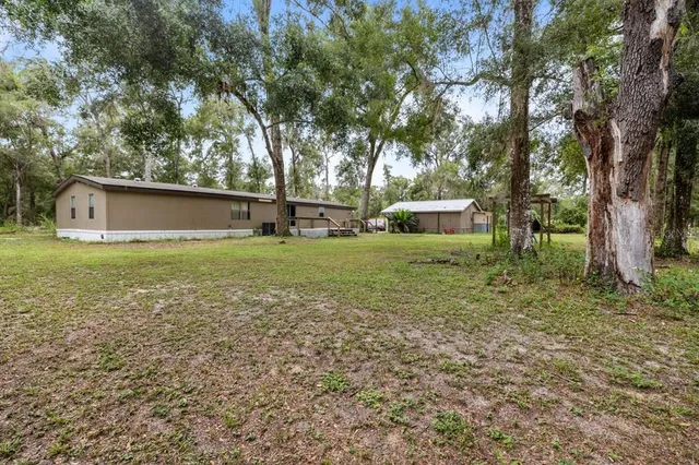 a big yard with lots of green space and deers