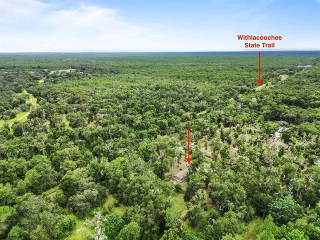 a kitchen with a refrigerator sink and cabinets