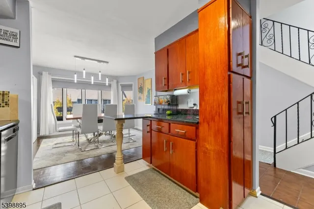 a large kitchen with stainless steel appliances granite countertop a refrigerator and a stove top oven