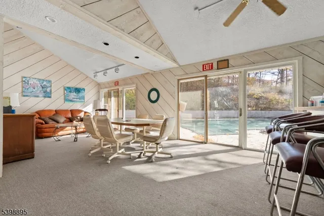 a view of a livingroom with furniture and a large window