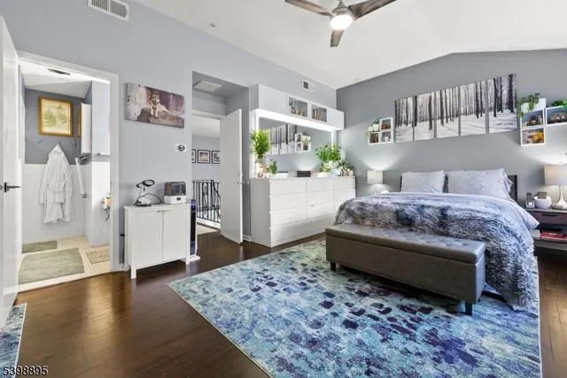 a living room with a bed furniture and kitchen view