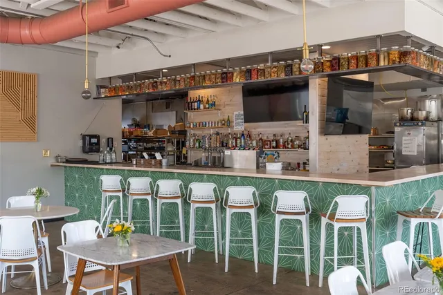 a view of a patio with table and chairs under an umbrella