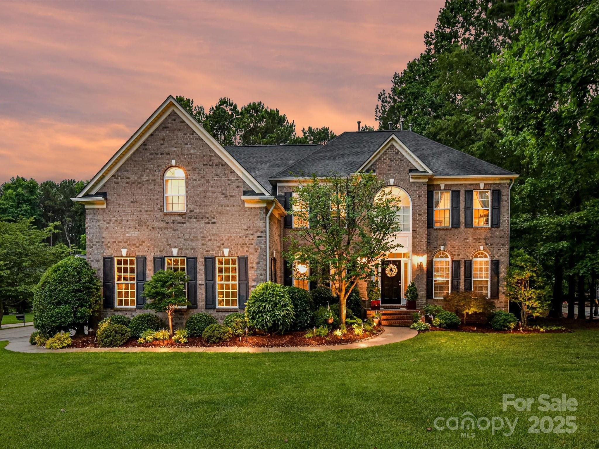 105 Beech Bluff Drive Mount Holly, NC 28120 - Photo 1 of 48 a front view of a house with a yard table and chairs