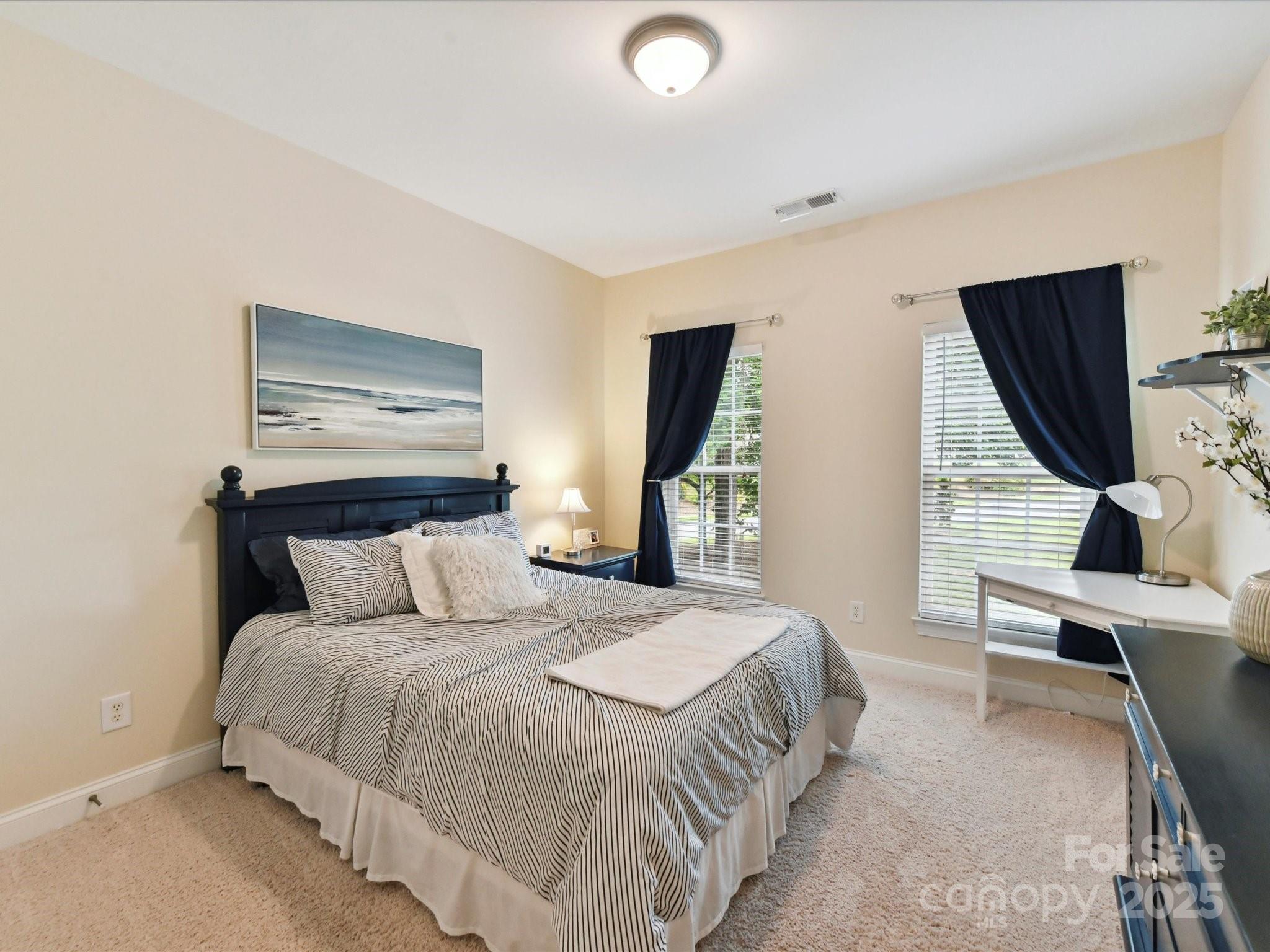 105 Beech Bluff Drive Mount Holly, NC 28120 - Photo 18 of 48 a bedroom with a bed and large mirror