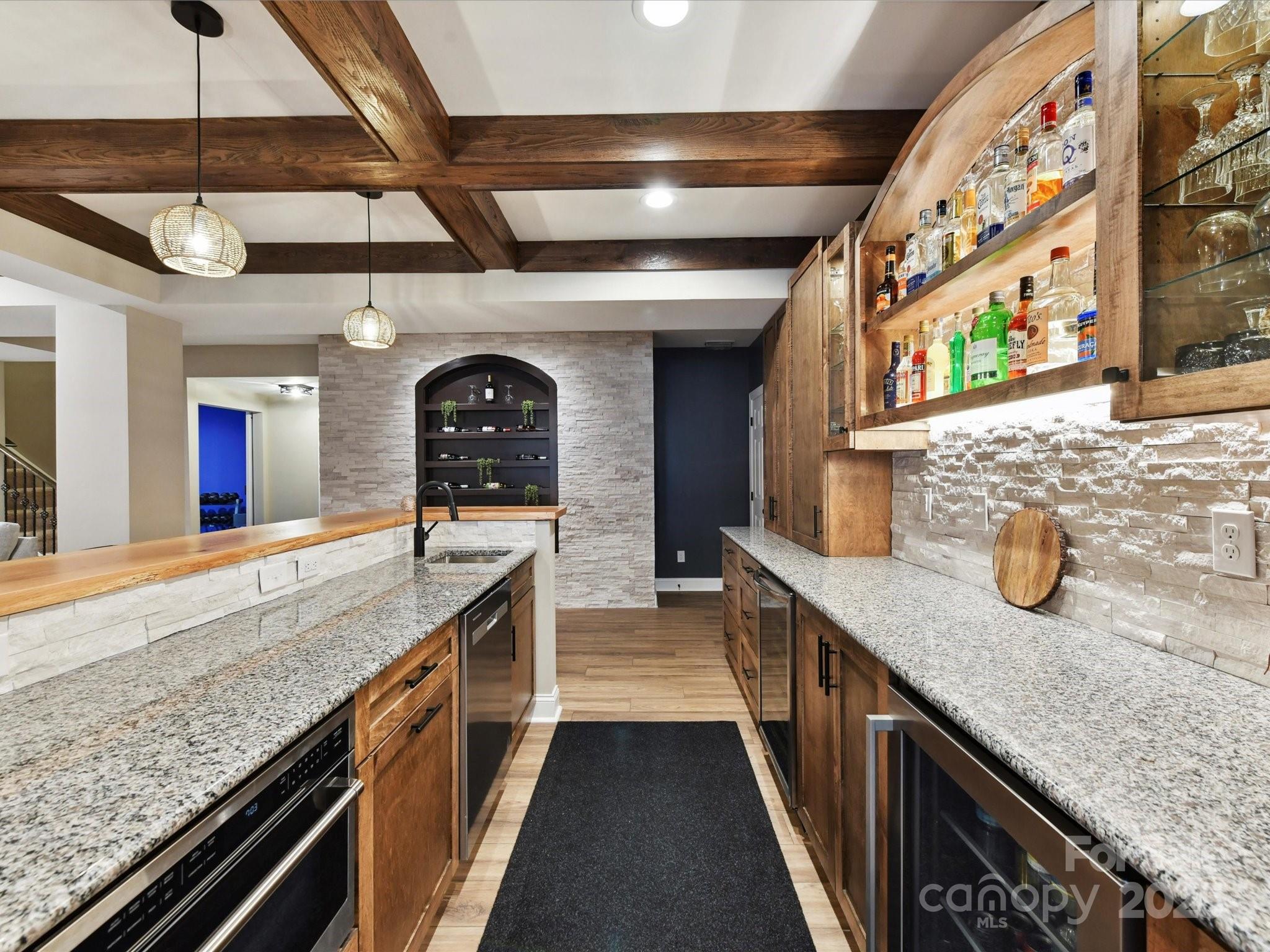 105 Beech Bluff Drive Mount Holly, NC 28120 - Photo 23 of 48 a kitchen with granite countertop a sink and a refrigerator