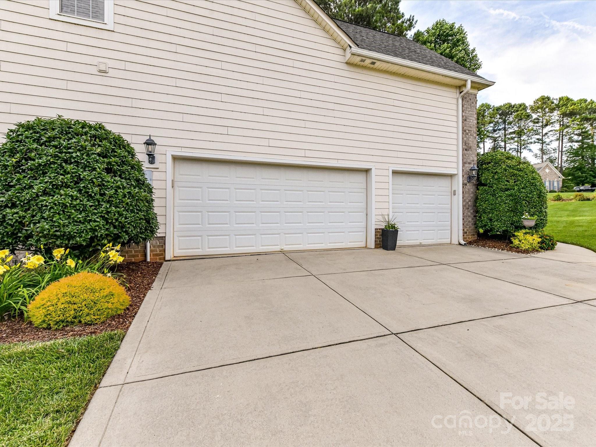 105 Beech Bluff Drive Mount Holly, NC 28120 - Photo 28 of 48 a view of garage and yard