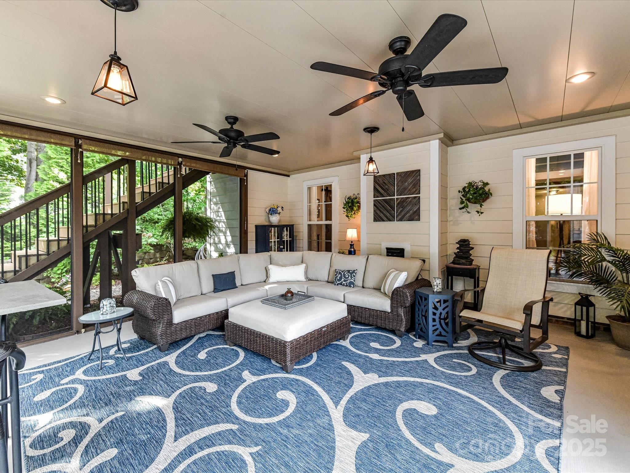 105 Beech Bluff Drive Mount Holly, NC 28120 - Photo 33 of 48 a living room with furniture ceiling fan and a large window