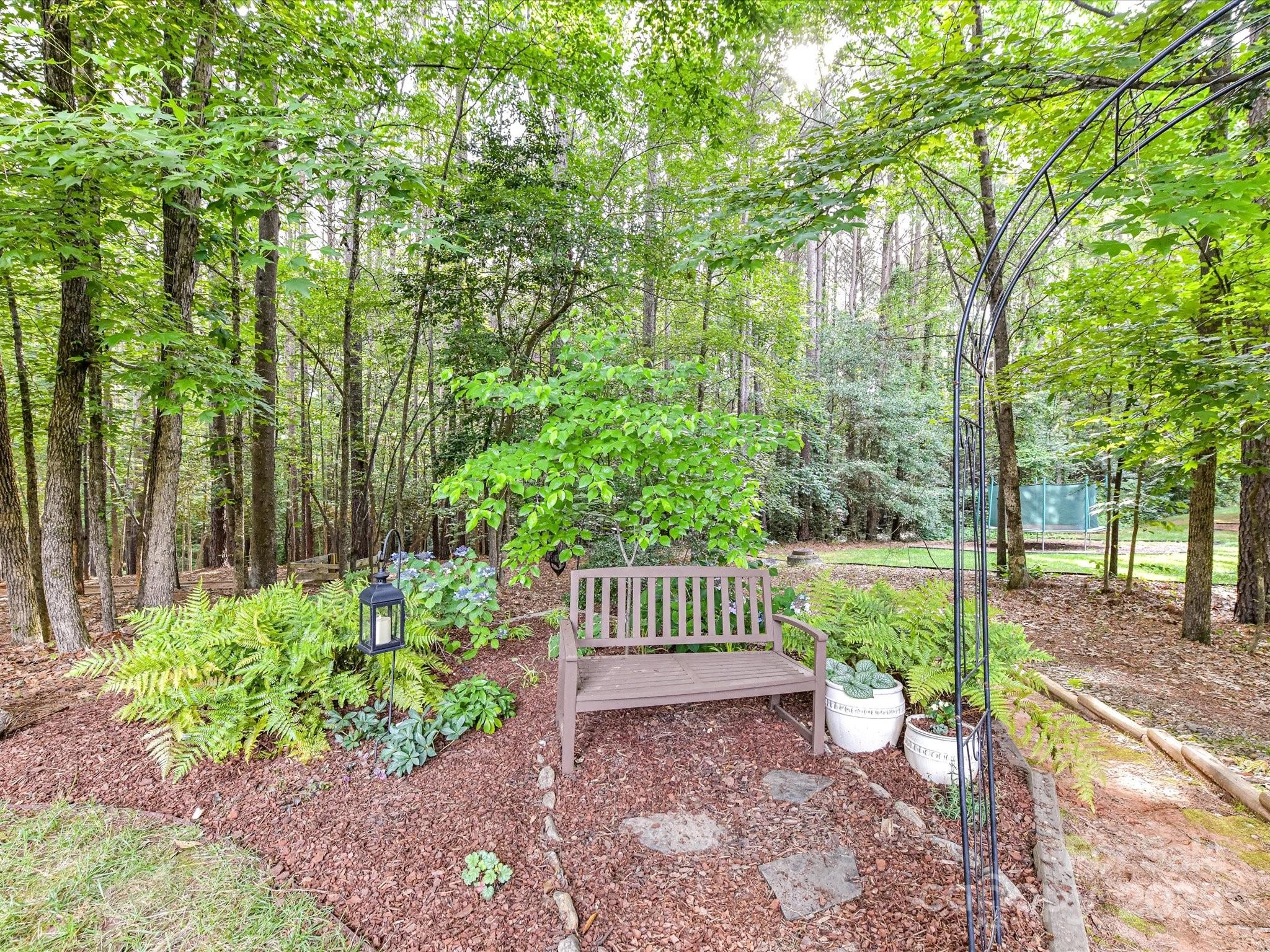 105 Beech Bluff Drive Mount Holly, NC 28120 - Photo 39 of 48 a view of a garden with patio
