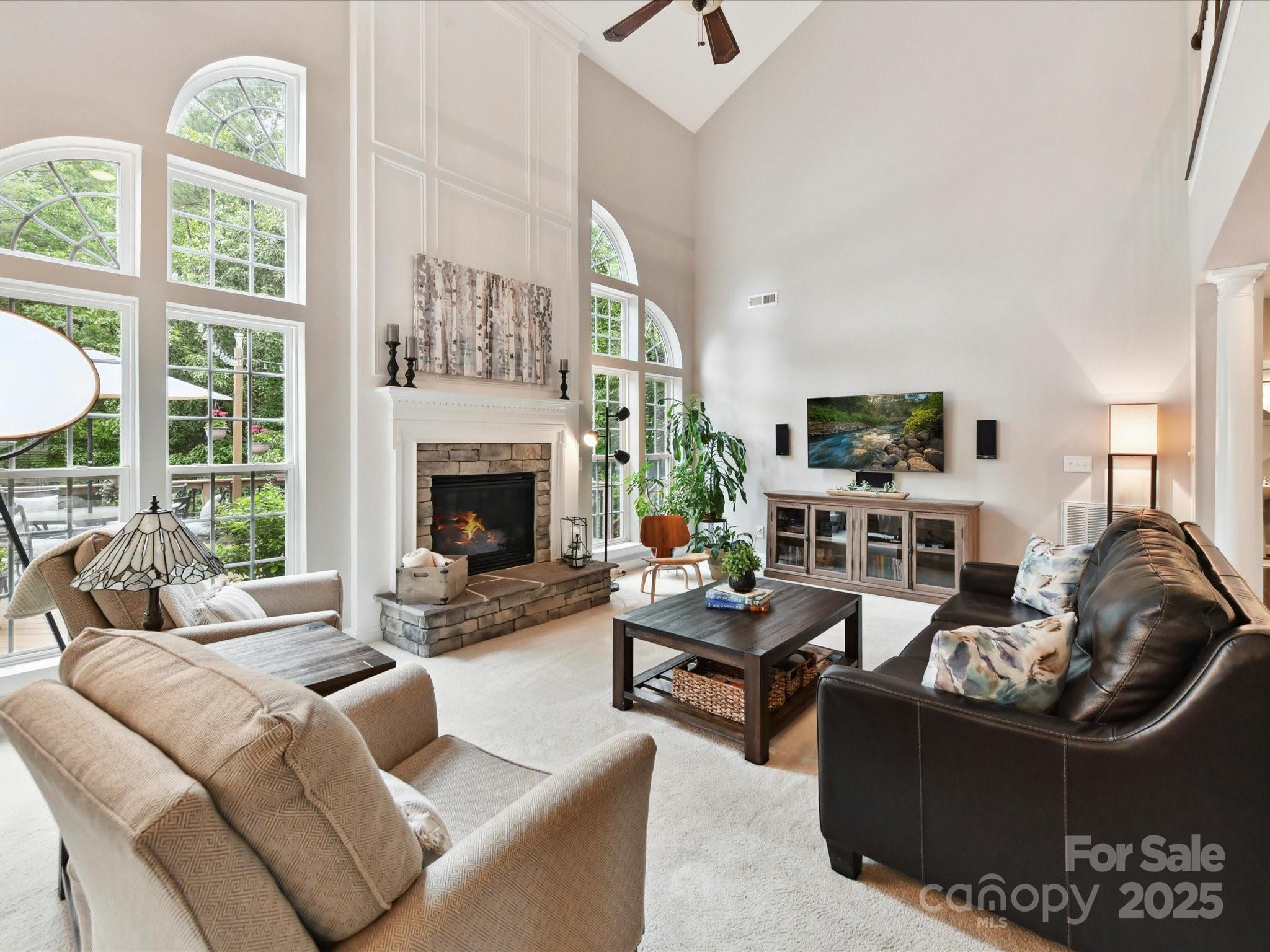 105 Beech Bluff Drive Mount Holly, NC 28120 - Photo 10 of 48 a living room with furniture a fireplace and a floor to ceiling window
